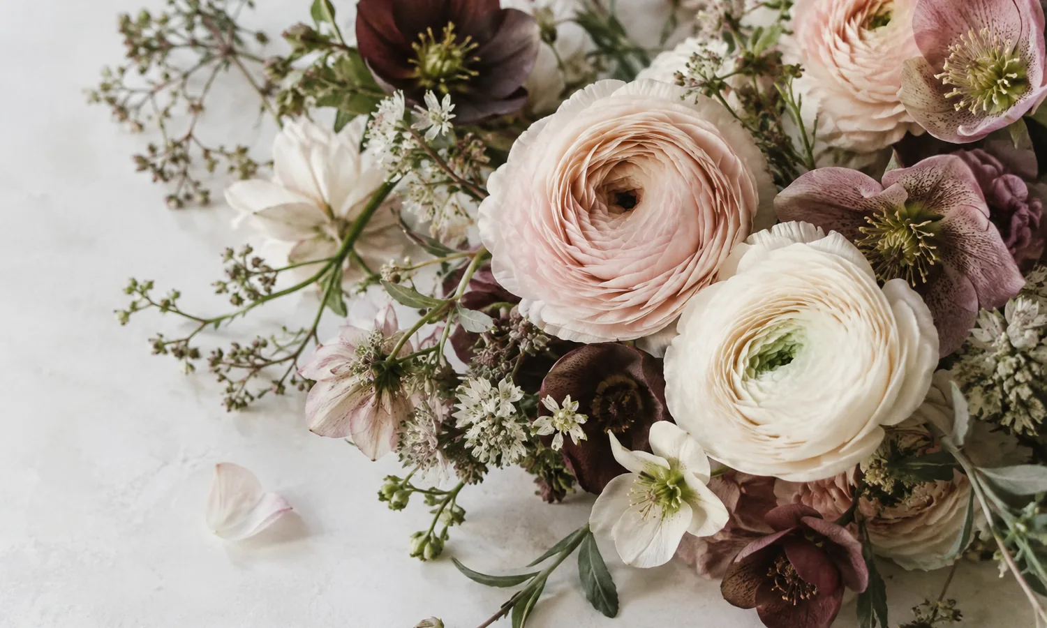 Detall de flors clares i rosades amb accents de color vi